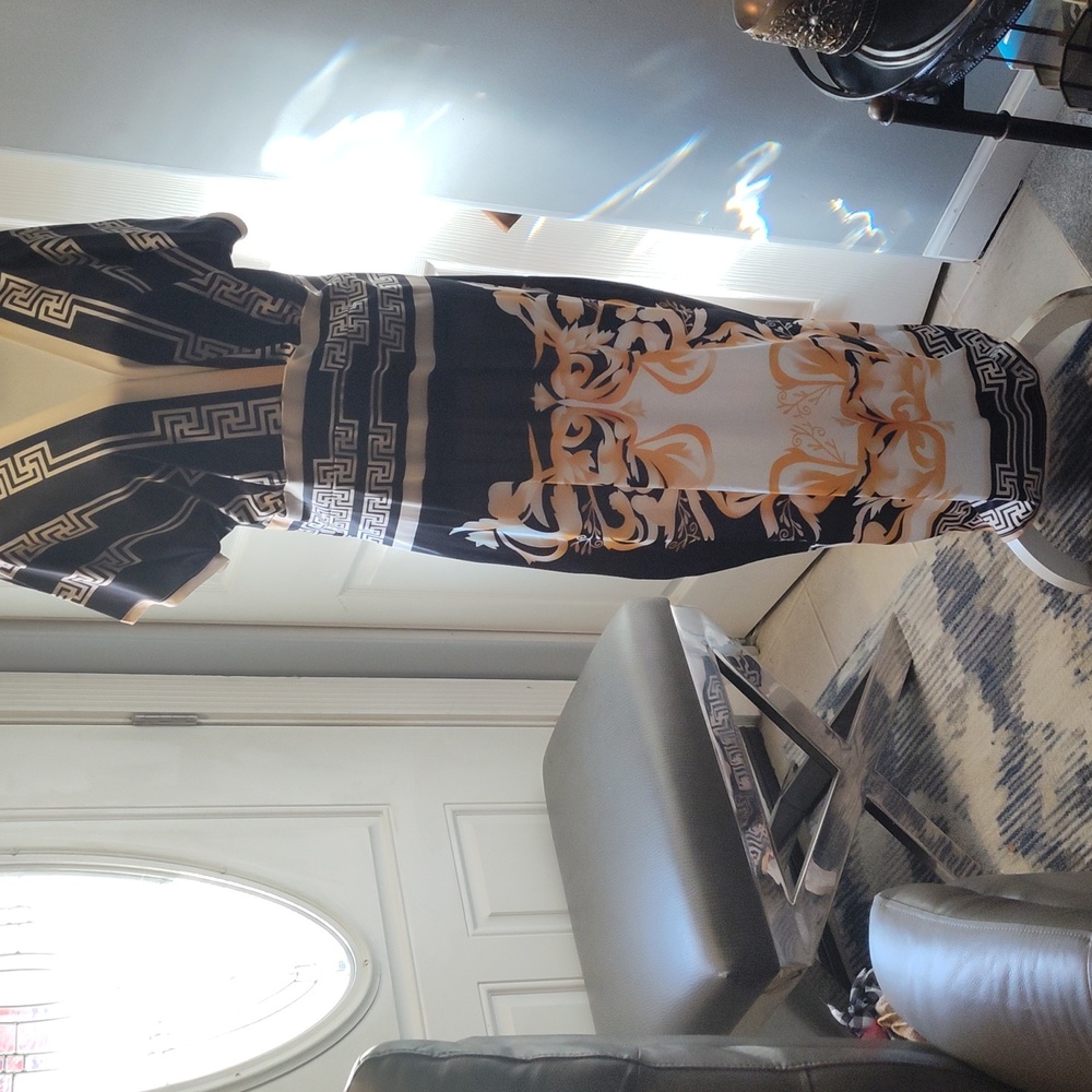 This dress has a plunging neckline and lots of detail.